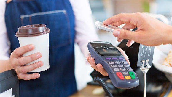 Customer Paying Through Mobile Phone In Cafe