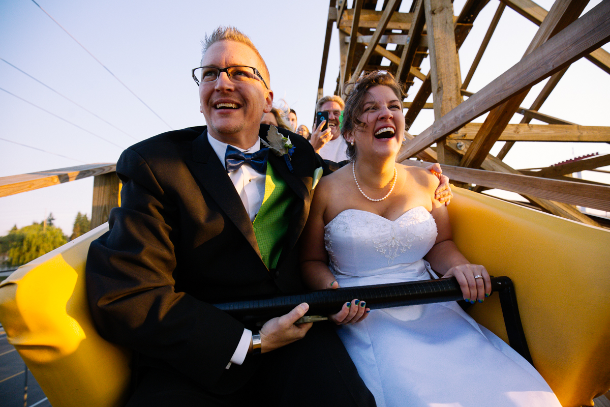 Holly Shelvock and Sean Schuhrieman of Sultan, WA tied the knot atop the Washington State Fair’s Classic Roller Coaster this morning. The couple were the winners of STAR 101.5 FM’s Washington State Fair Roller Coaster Wedding contest. The couple received rings from Chippers Jewelry in Bonney Lake, tuxedo rentals from The Tux Shop, a reception at The Fair with fair scones, a cake from Morfey’s Cake, fresh-cut flowers from Blooms at the Windmill Inn in Sumner and wedding night accommodations at Holiday Inn Express and Suites Puyallup.  The couple met while both serving in the Navy, and have been dating for 10 years. Shelvock and Schuhriemen have two sons together, Gavin, 6, and Declan, 3. (Image: Joshua Lewis / Seattle Refined)